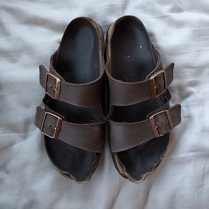 Arizona Birkenstocks (holding)